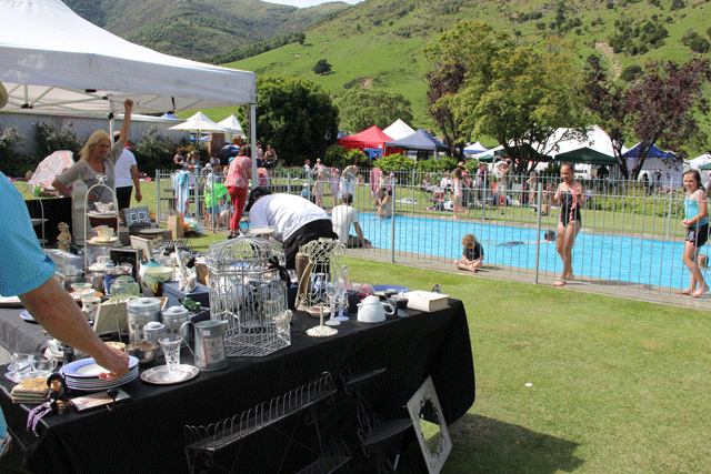 Stalls beside the pool at the Manderley Home and Garden Festival